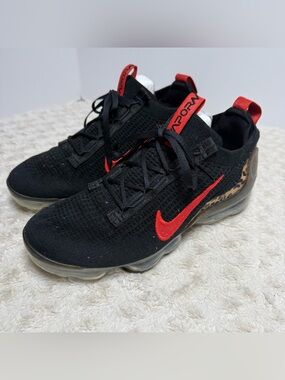 Nike Black Athletic Shoes with Red Swoosh and Leopard Accent